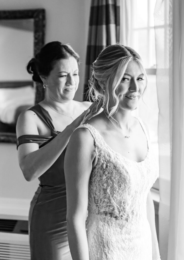 mom helping the bride put her necklace on