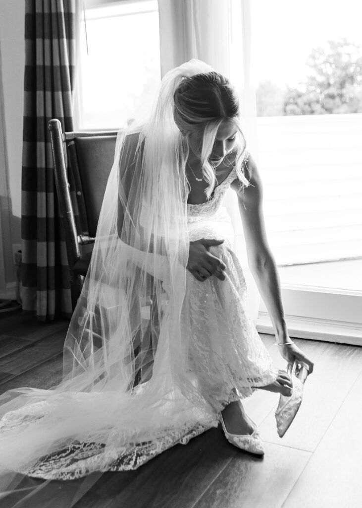 bride puts wedding shoes on