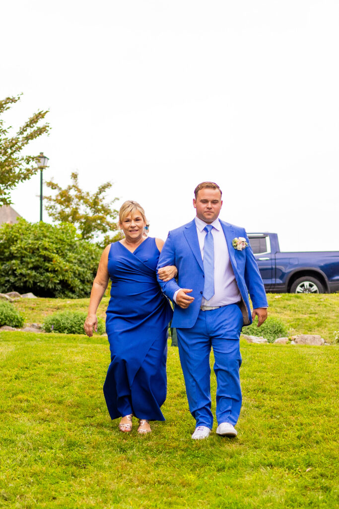mom and the groom walk down the aisle