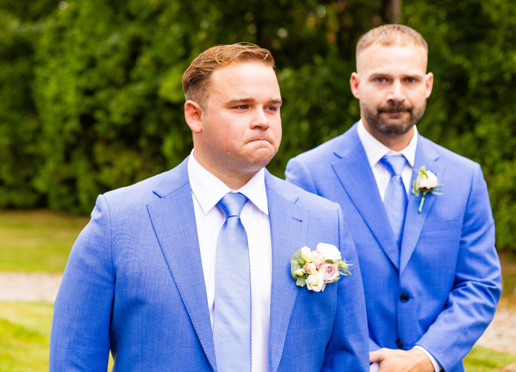 groom shedding a tear as his bride walks down the aisle at their NH lakeside wedding 