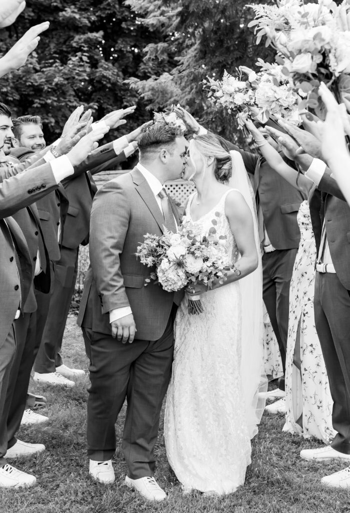 bride and groom share a kiss under the tower