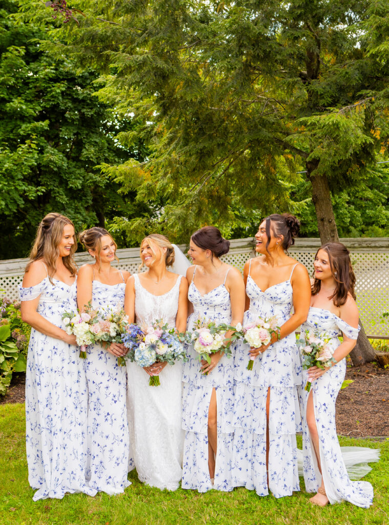 bride and bridesmaids sharing a laugh at their meredith nh wedding 