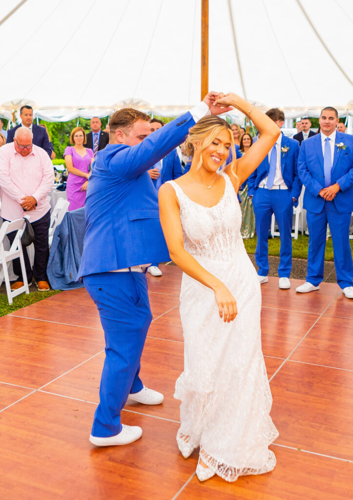 groom spins his bride during their first dance
