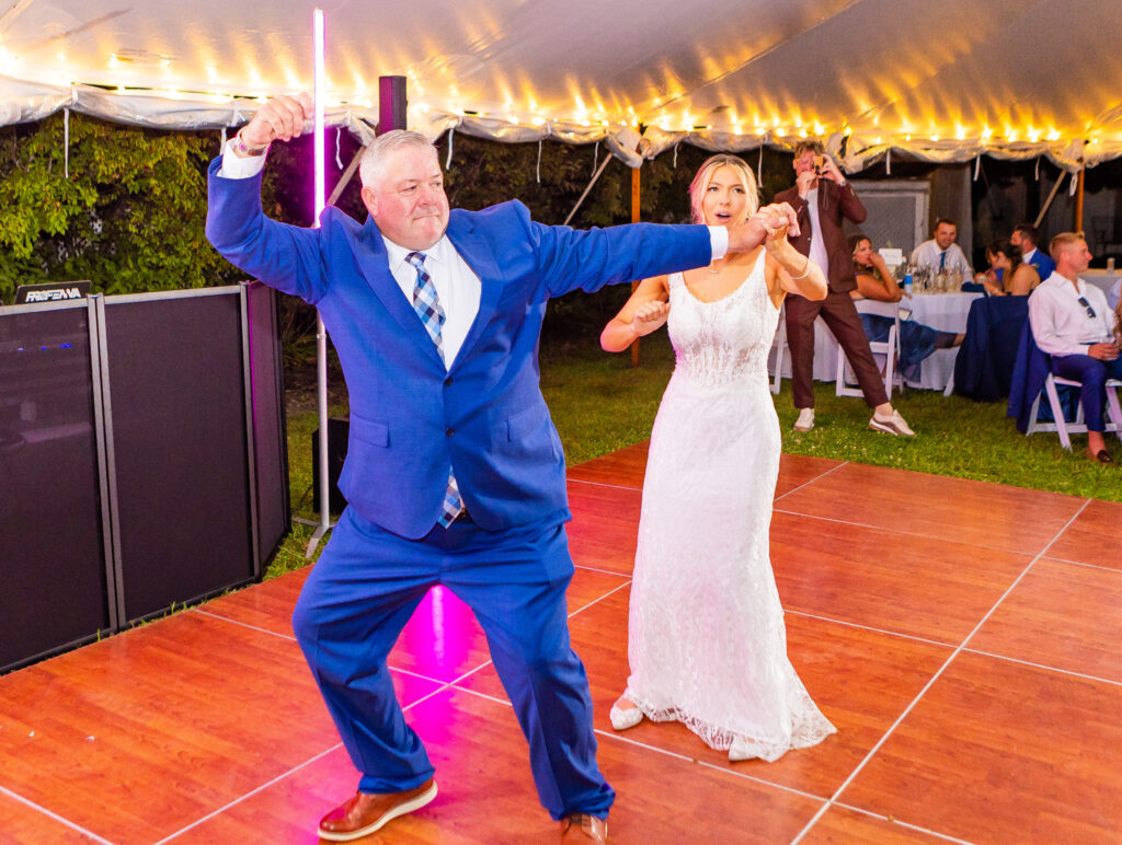 bride and father busting a move on the dance floor