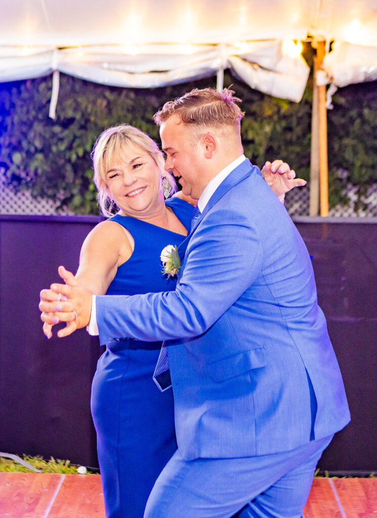 groom and son dancing at the wolfeboro inn in the lakes region of new hampshire