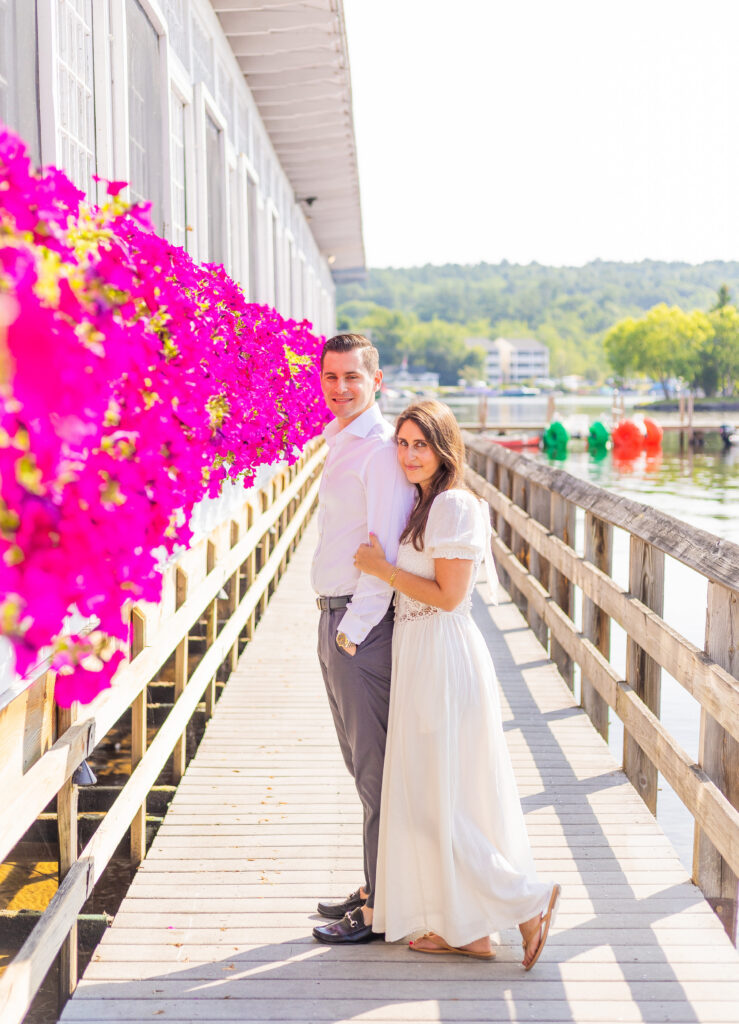A couple doing engagement photos in front of Lago in Meredith NH.